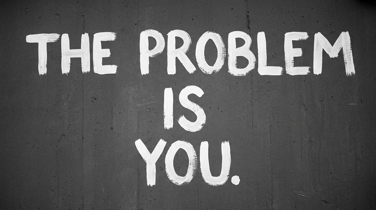 The Problem Is You painted in white brush strokes on a concrete wall